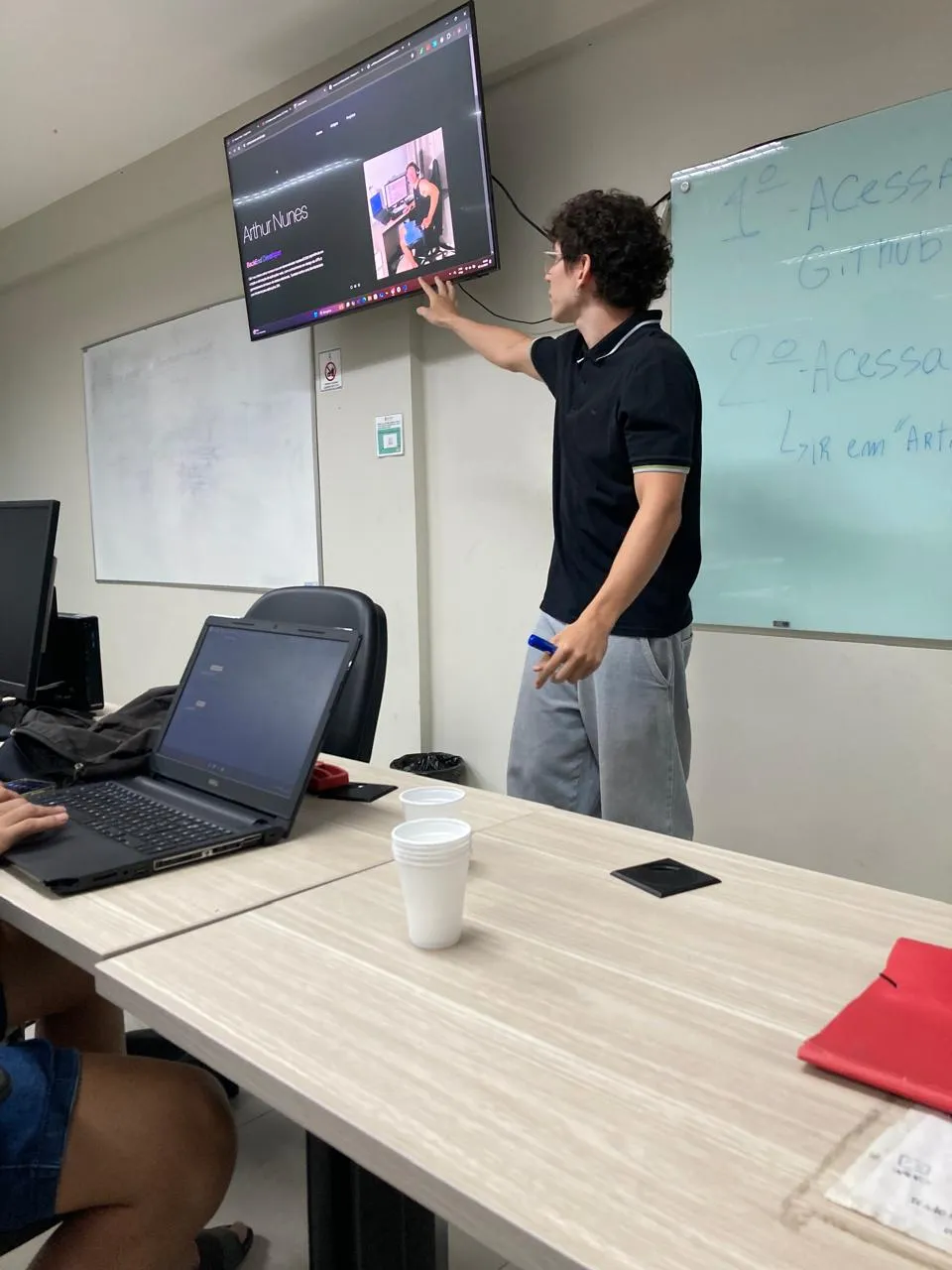 Arthur presenting his portfolio on a classroom TV at IFPA